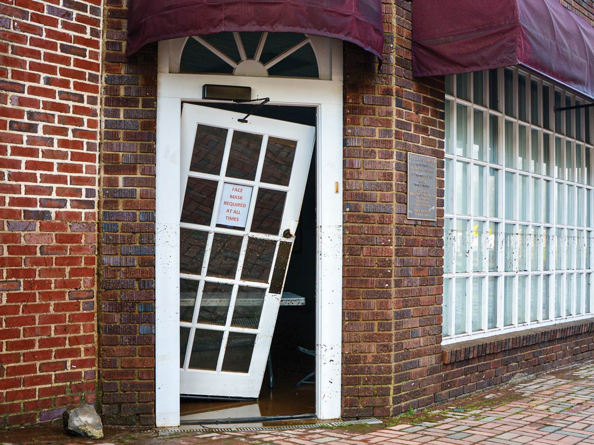 The door to the Colonial Theatre’s annex hangs limply from its hinges following flooding on Aug. 17, 2021. Cory Vaillancourt photo