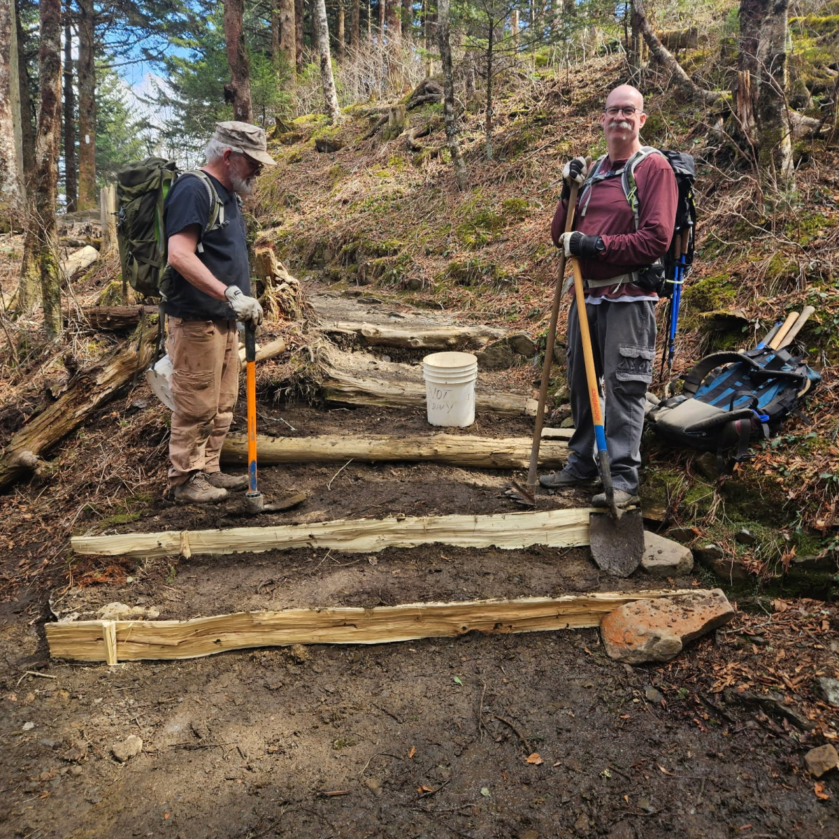 Smoky Mountains Hiking Club volunteers Rick Waggener (left) and Brian Woods install new steps near Icewater Spring.