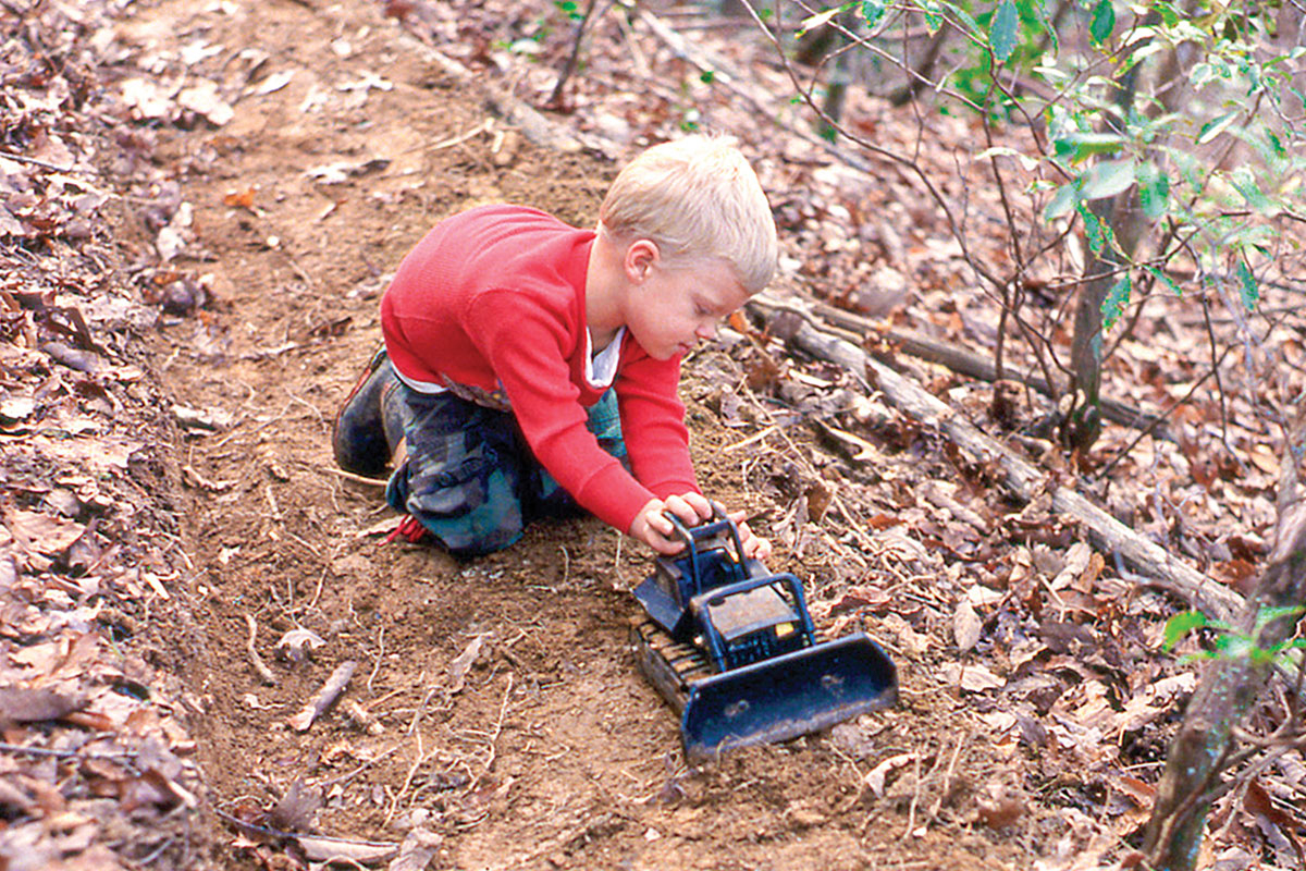 In 1994, Henry Kornegay helped his father build trail with his toy bulldozer. Burt Kornegay photo