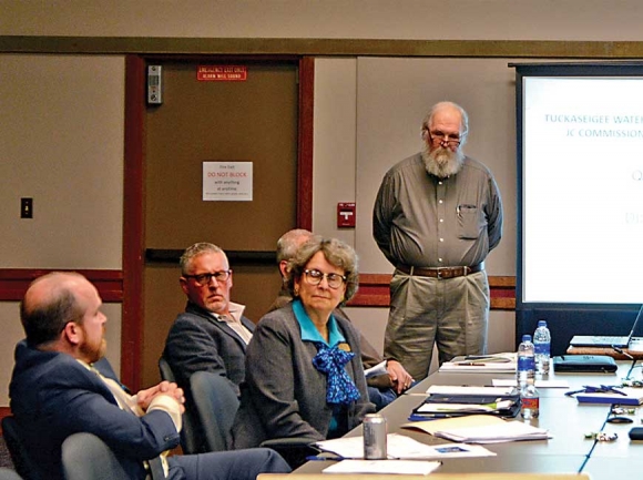 TWSA Executive Director Dan Harbaugh (standing) updates Jackson County Commissioners on research into the potential for a Cashiers water system. Holly Kays photo