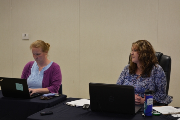 Shining Rock Board Secretary Melanie Norman (left) and Chair Michelle Haynes listen to a speaker during a June board 19 meeting.