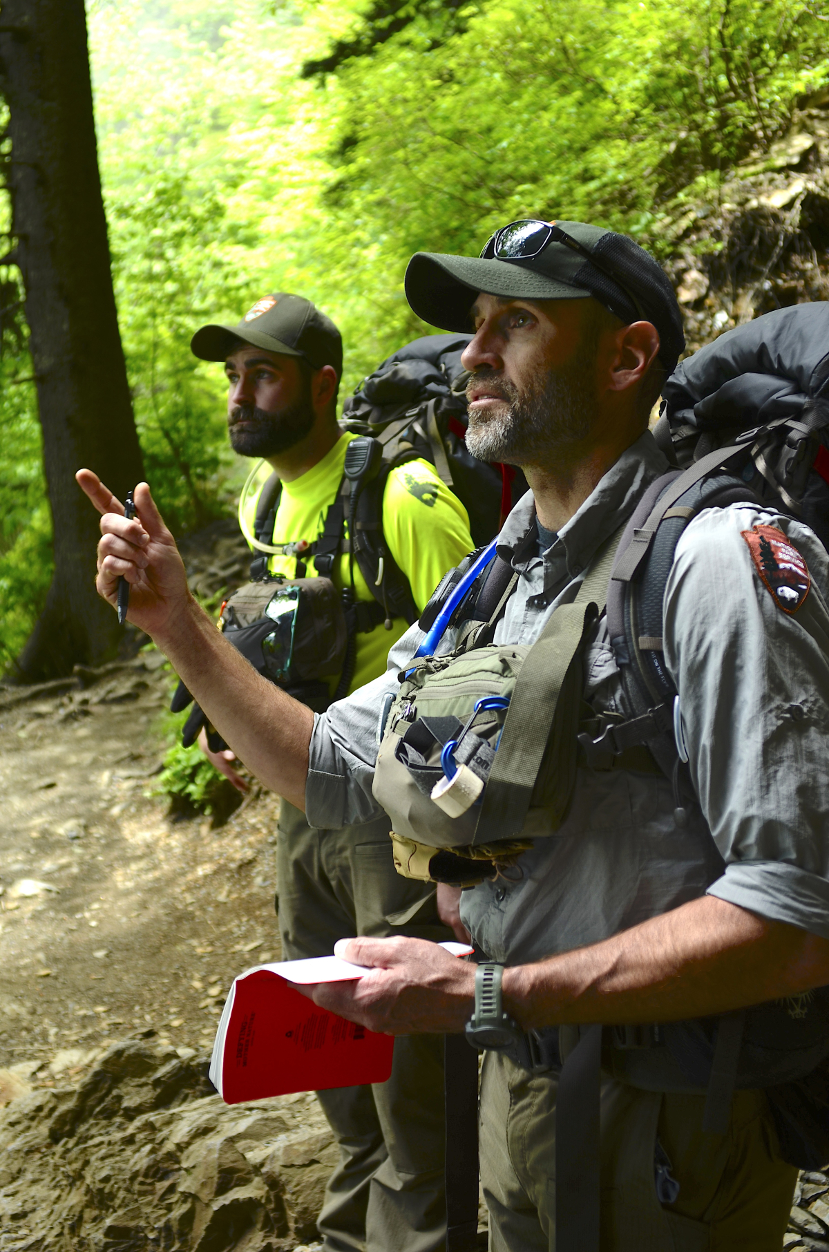 Supervisory PSAR Ranger Joshua Albritton speaks with a group of hikers descending the trail from Mount Le Conte.