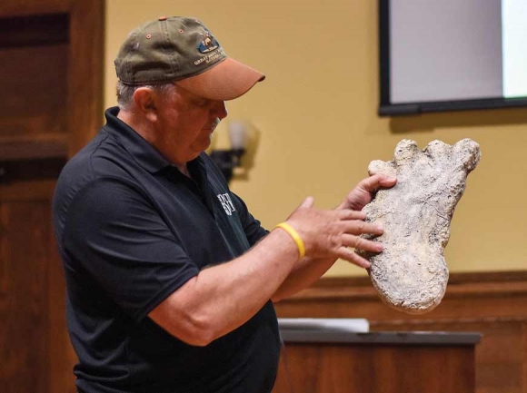 Holding a casting of a Bigfoot track, Carpenter discusses his understanding of the as-of-yet scientifically unacknowledged native primate known as Bigfoot. Holly Kays photo 