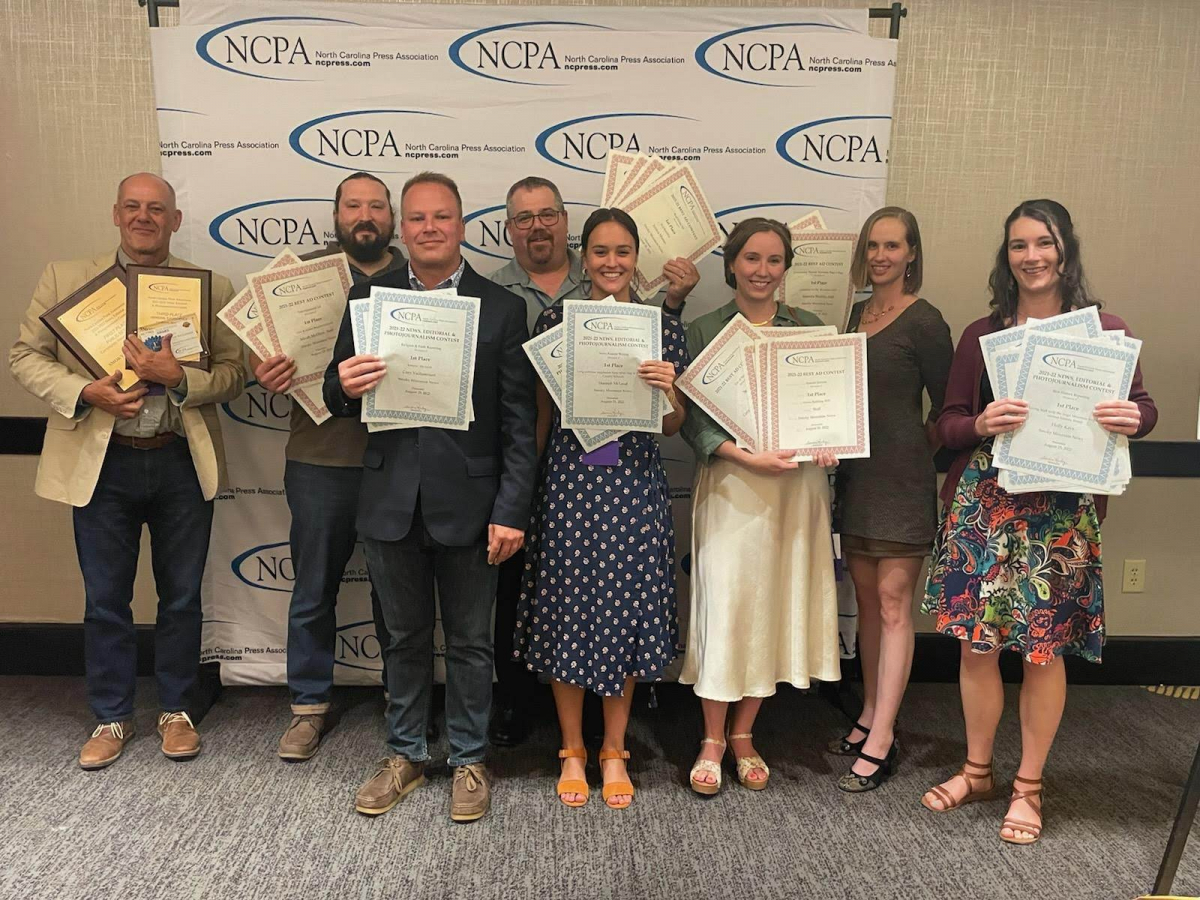 Smoky Mountain News staffers (from left) Scott McLeod, Kyle Perrotti, Cory Vaillancourt, Greg Boothroyd, Hannah McLeod, Sophia Burleigh, Jessica Murray and Holly Kays holding awards at the N.C. Press Association ceremony held Aug. 24 in Raleigh.
