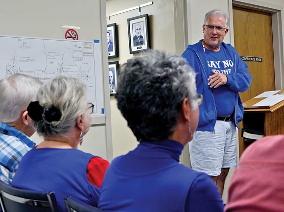 Rick Bryson, owner of Bryson’s Car Wash, tells commissioners and audience members why he opposes the road plan. Holly Kays photo 