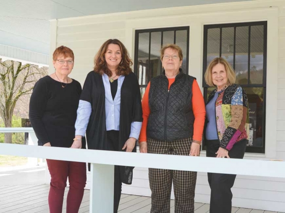 Appalachian Women’s Museum board members stand on the porch of the building in Dillsboro. Pictured left to right are treasurer Debi Sullivan, past president Cathy Monteith Busick, current president Sharon Sullivan and vice president Marty Greeble. 