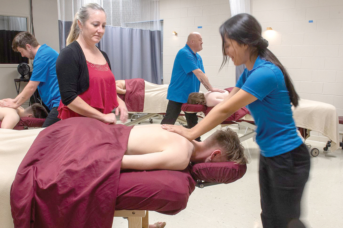SCC Therapeutic Massage instructor Jennifer Burgess (left) offers guidance to student Stephanie Ortiz Ruiz of Franklin on proper shoulder massage techniques. Donated photo