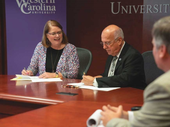 Western Carolina University Chancellor Kelli R. Brown (left) and Asheville-Buncombe Technical Community College President Dennis King sign a memorandum of understanding between the two institutions of higher education. Samuel Wallace