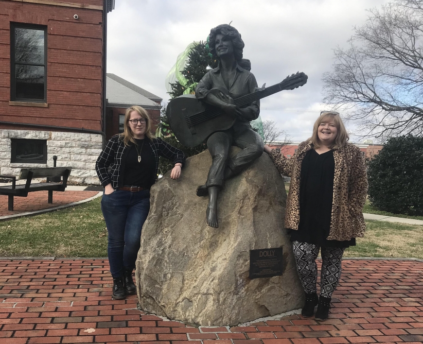 Jessi and Leilah Stone pictured next to the Dolly Parton statue, Christmas 2018.