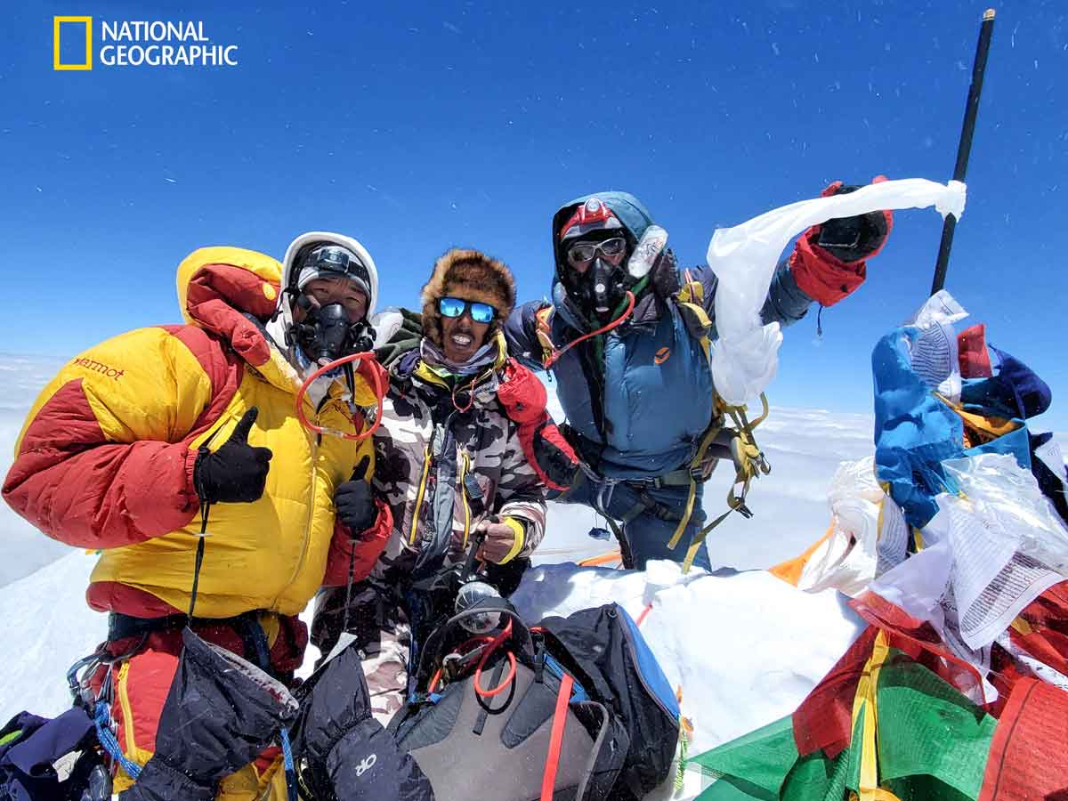 Tenzing Gyalzen Sherpa, Kami Temba Sherpa, and Nima Kancha Sherpa stand at the summit of Everest during a May expedition. Arbindra Khadka/National Geographic photo