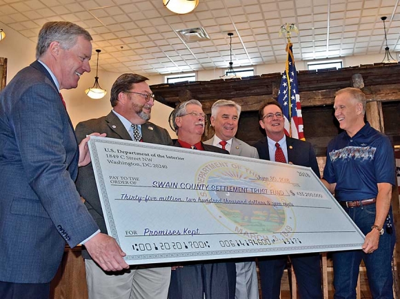 U.S. Rep. Mark Meadows, (from left) Swain County Commission Chairman Phil Carson, Rep. Mike Clampitt, Sen. Jim Davis, Rep. Kevin Corbin and U.S. Sen. Thom Tillis pose for a $35.2 million check presentation to Swain County, closing out the North Shore Road settlement. Jessi Stone photo