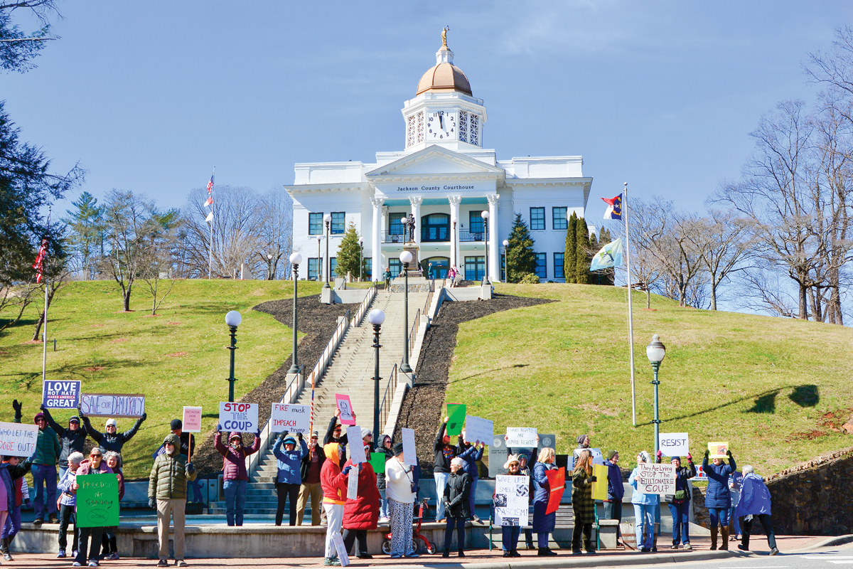 A small, noisy and growing group of demonstrators voiced opposition to President Donald Trump and his advisor Elon Musk near the steps of the Jackson County Library in Sylva on Feb. 17. Cory Vaillancourt photo 