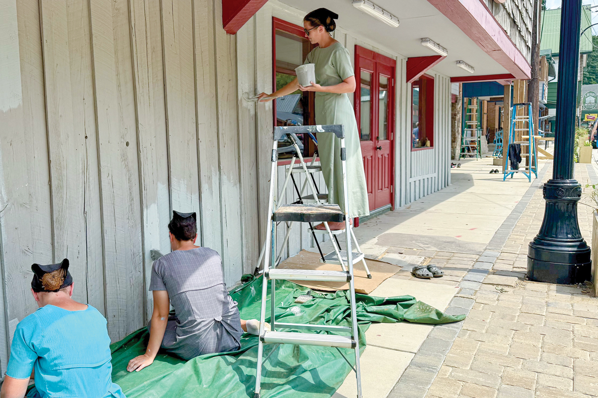 Volunteers from Centre County, Pennsylvania, slap a new coat of paint on a building in Chimney Rock on Aug. 21. 