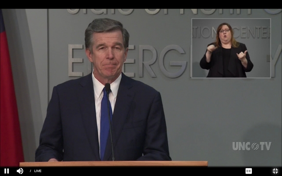 Gov. Roy Cooper (left) holds a press conference on May 20. 