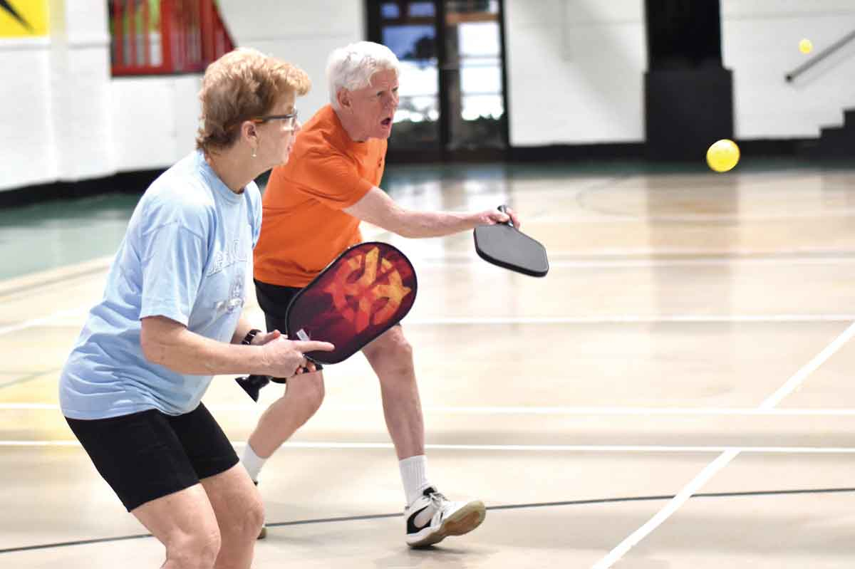 Players return a volley during a pickleball game at the Old Armory in Waynesville. Holly Kays photos 