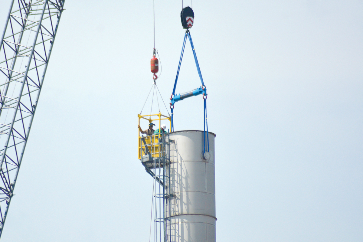 Workers inspect one of the smokestacks at Pactiv Evergreen’s Canton paper mill on Aug. 21.  Cory Vaillancourt photo