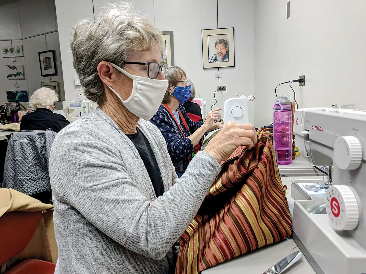 Lori Stephens works on a bag during a Feb. 11 sew-a-thon at the Haywood County Public Library in Waynesville. Holly Kays photo