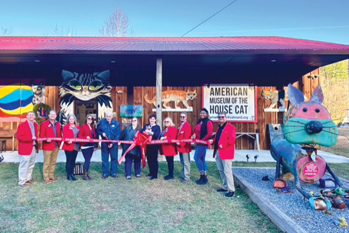 From left are Chamber Ambassadors Chad Gerrety, Matt Saenger, Marne Harris, Patricia Bryson-Wink, American Museum of the House Cat Director Harold Sims, Marketing Director Kimberly Crow, Museum Manager Julie Kimbrell (holding official museum cat Mimi), and ambassadors Patricia Stanberry, Karson Walston, Natalie Newman and Chris Stuckey.