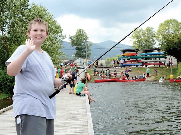A camper waves from the dock at Lake Junaluska after an afternoon of fishing and canoeing. Holly Kays photo