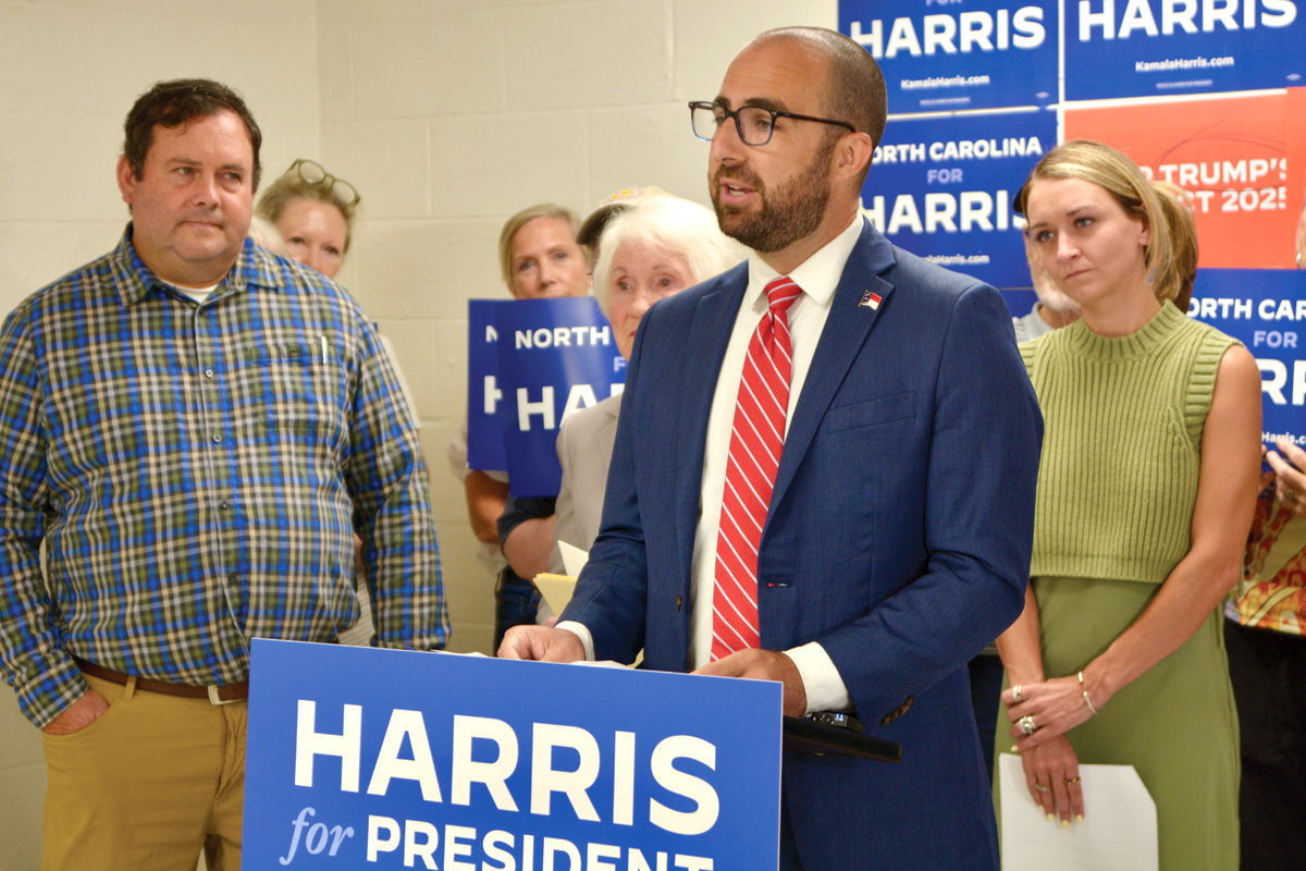 Democratic Rep. Eric Ager (left) and state party Chair Anderson Clayton (right) look on as Rep. Caleb Rudow speaks during an Aug. 14 press conference. Cory Vaillancourt photo