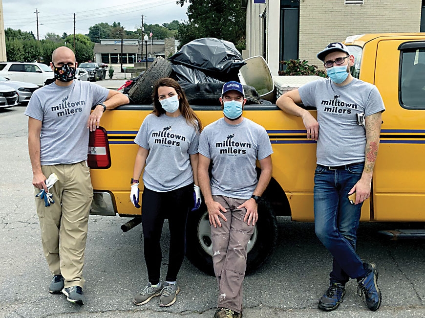 Mike Howell (from left), Katie Warren, Corey Alexander and Jason Pierson show off the trash removed from the Canton area. Donated photo 