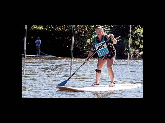 WCU student Charlotte Masters heads toward a third-place finish in the Cullowhee Canoe Slalom paddleboard race. WCU photo