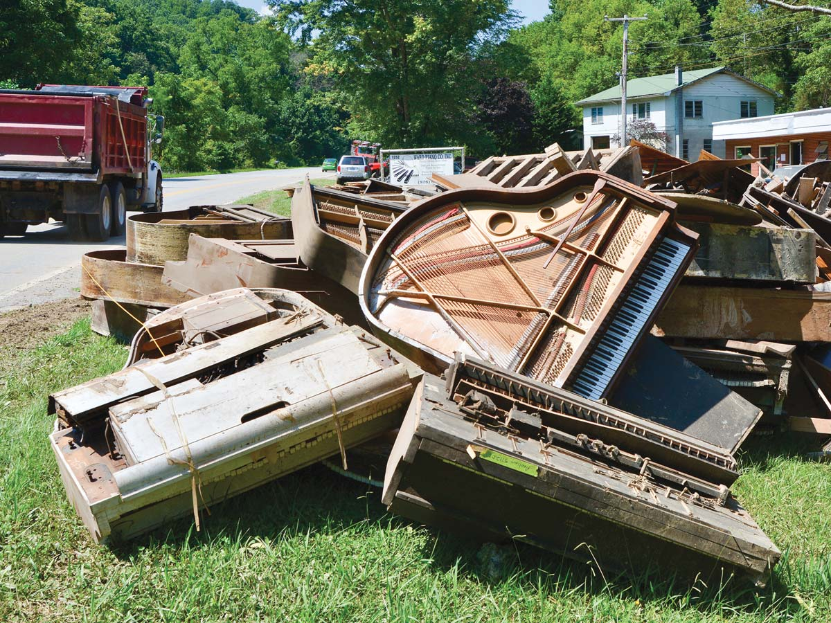 Pianos piled outside of the Ward Piano Company in Canton are a testament to the devastating floods in Haywood County last summer. Cory Vaillancourt photo