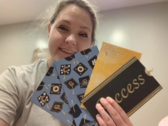 SMHS senior Brianna Buchanan fans out the cards she’s received from the Smoky Mountain High School Adopt-A-Senior program. Donated photo