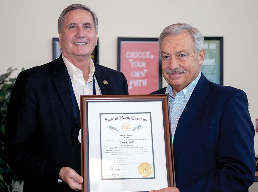 Terry Bell (right) receives The Order  of the Long Leaf Pine from SCC President Dr. Don Tomas.