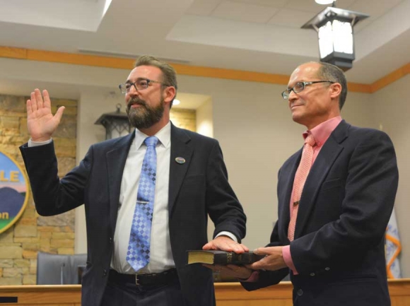 Anthony Sutton (left) takes the oath of office as husband Joey Del Bosque stands beside him. Cory Vaillancourt photo