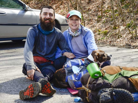 Thru-hikers Greg Boului and Cricket Cote wait for a shuttle at Winding Stair Gap with their dog Roux. Holly Kays photo