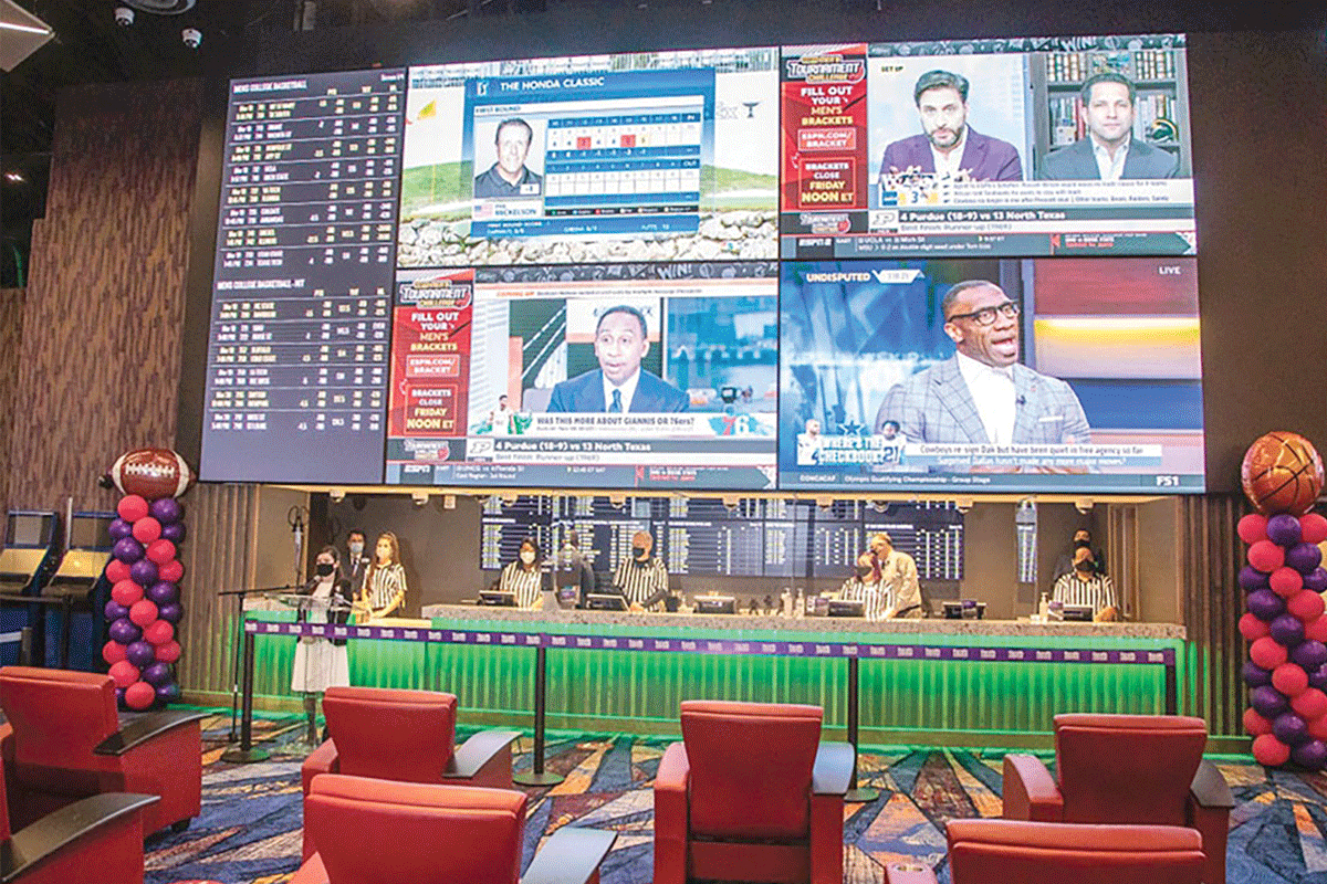 Casino employees stand ready to take the first bets at The Book in Cherokee in March 2021. Harrah’s Cherokee photo