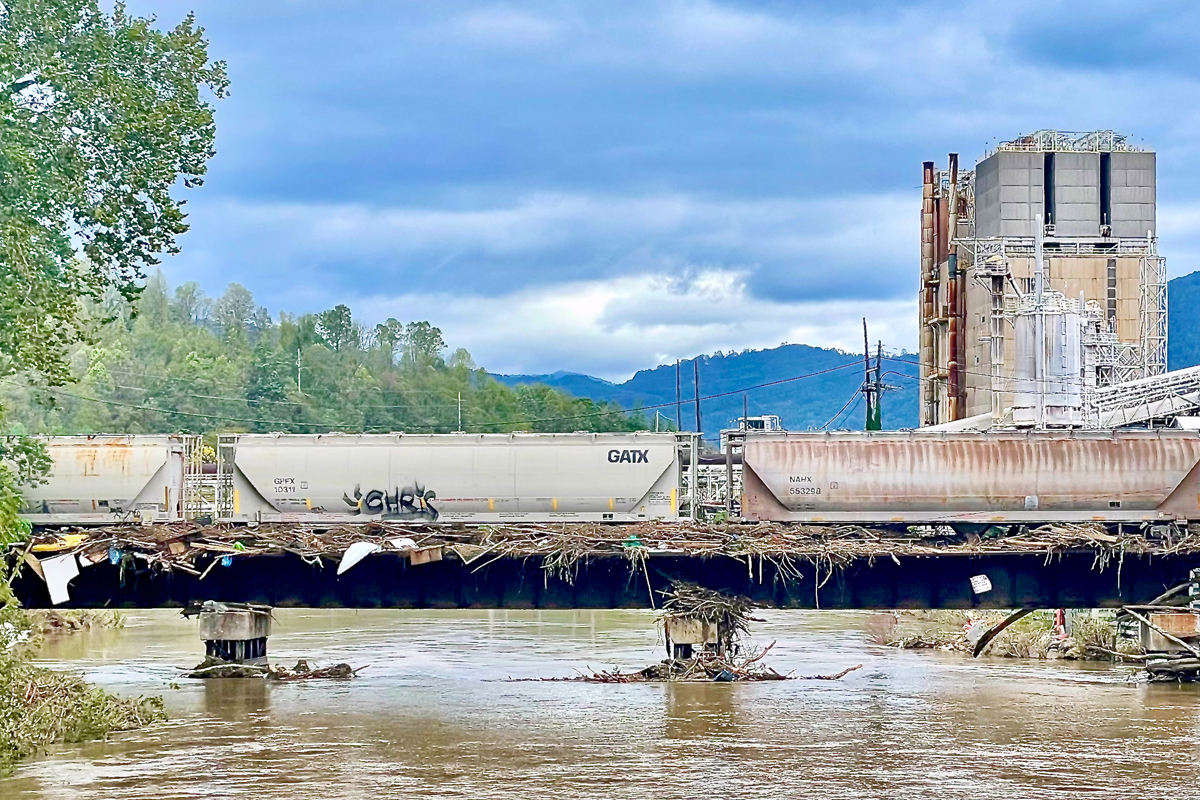 Storm debris lines a railroad bridge (foreground) leading to Pactiv Evergreen’s Canton mill on Saturday, Sept. 28. Cory Vaillancourt photo