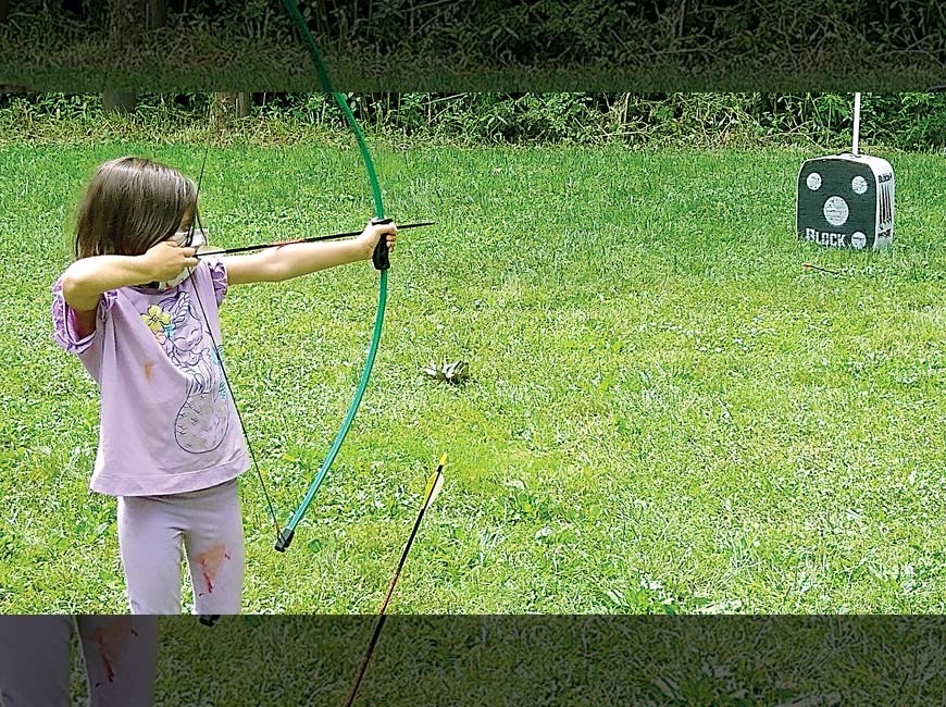 A Cub Scout fires an arrow in the archery range. John Mills photo