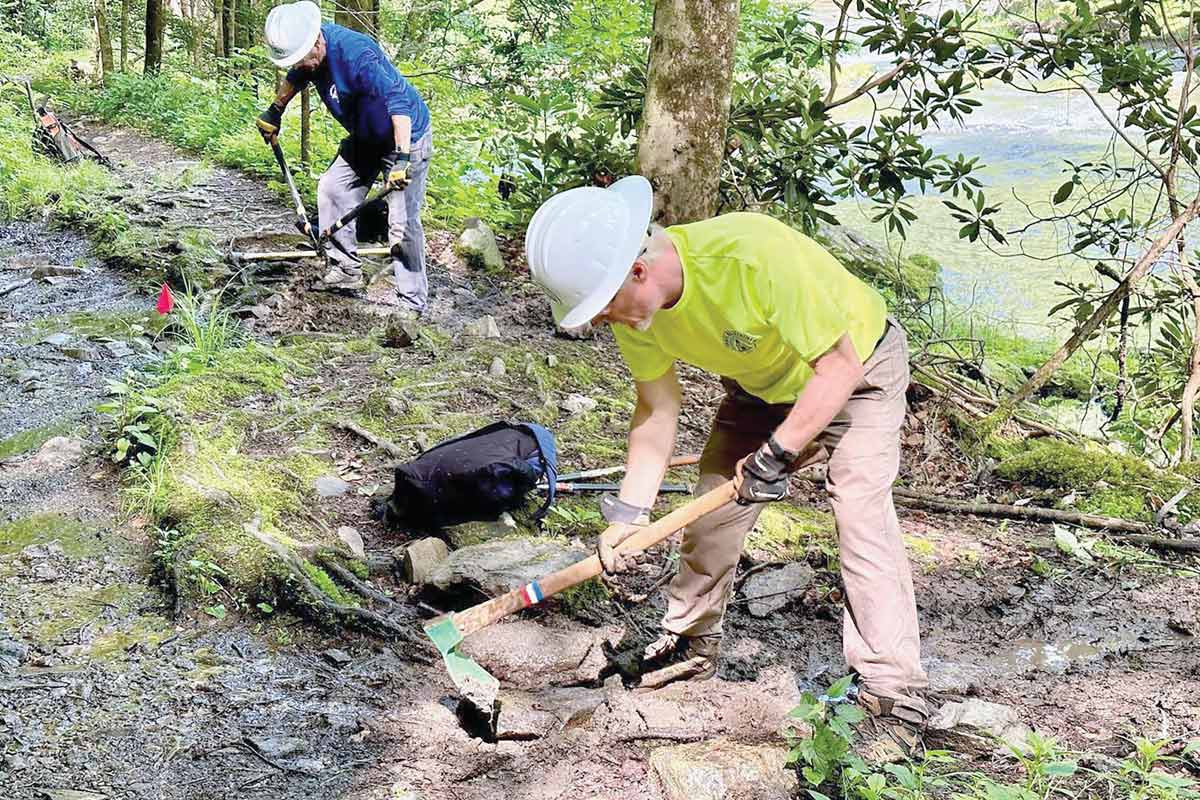 Carolina Mountain Club volunteers work on a trail along Big Laurel Creek near Hot Springs during a June 4 workday. CMC photo