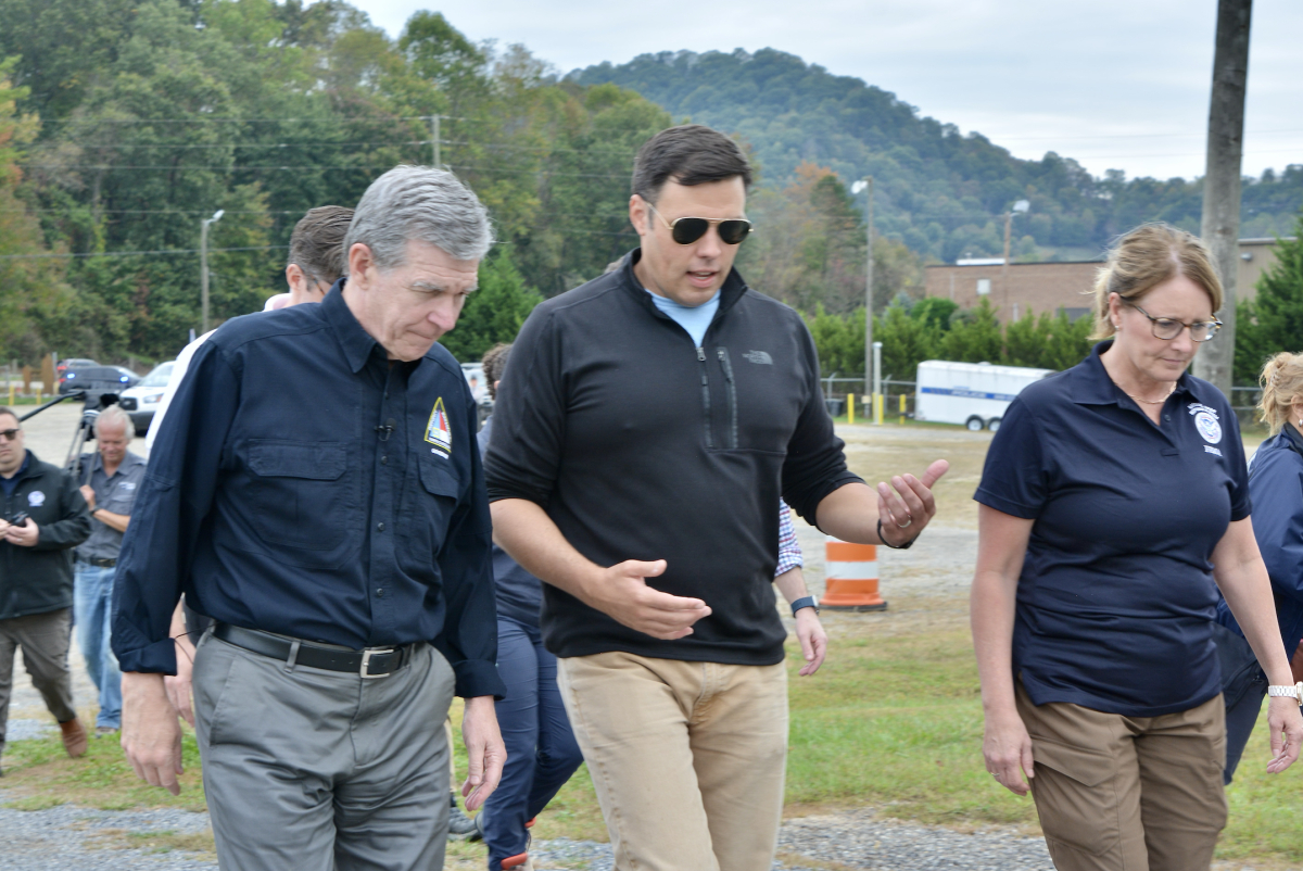 North Carolina Gov. Roy Cooper (left) chats with Canton Mayor Zeb Smathers and FEMA Administrator Deanne Criswell at the International Paper Sports Complex in Canton on Oct. 4. 