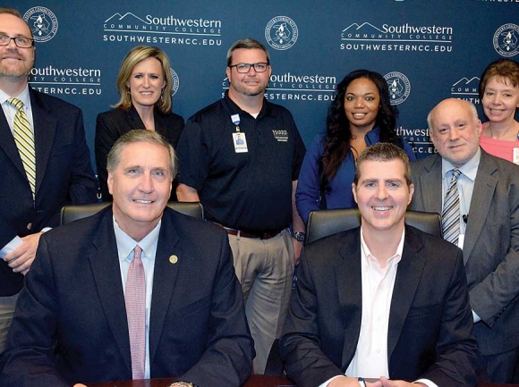 Dr. Don Tomas (front left), president of Southwestern Community College, and Steve Heatherly, president and CEO of Harris Regional Hospital, sign a memorandum of understanding to establish the SNAP program on June 11 at the college&#039;s Jackson Campus in Sylva. Donated photo 
