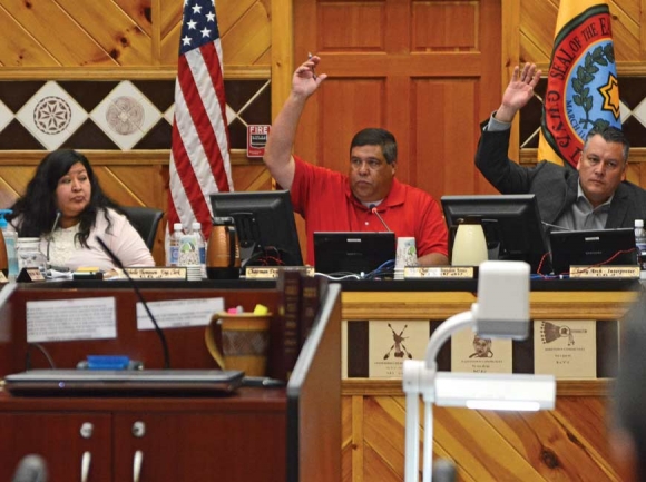 Tribal Council Chairman Bill Taylor (left) and Vice Chairman Brandon Jones raise their hands in favor of bringing impeachment charges against Principal Chief Patrick Lambert on April 6, 2017. Holly Kays photo