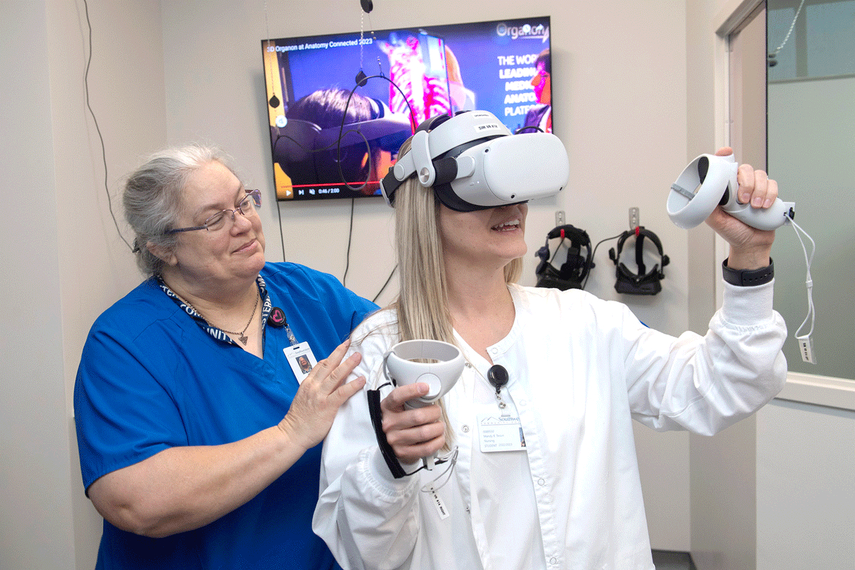 Jill Ellern, SCC’s Director of Healthcare Simulation Learning, shows Nursing student Mandy Tessin how to use some of the new virtual reality headsets.