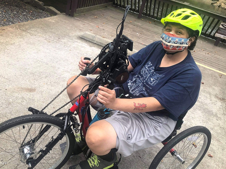 The handcycle allows Bradley, whose legs are paralyzed, to power the bike with her arms. Donated photos