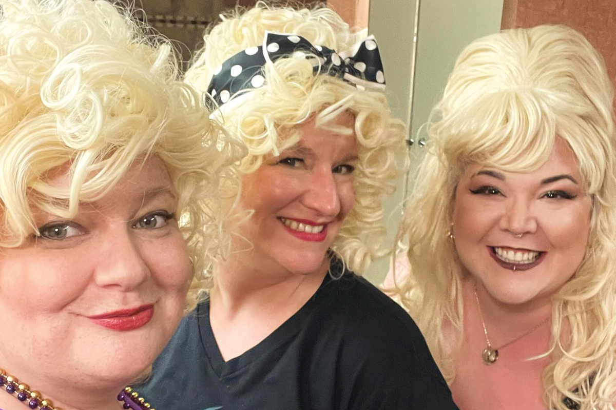 WOW members (left to right) Jessi Stone, Katie Vanderpool and Celeste Ybanez don their Dolly Parton wigs during the 2024 Mardi Gras Ball fundraiser for Haywood County Schools Foundation. Donated photo