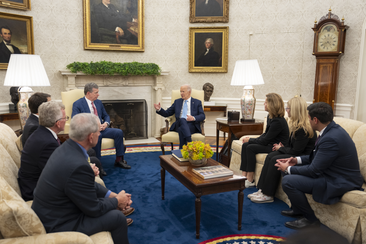 President Joe Biden (center) meets with North Caroline Gov. Roy Cooper (center-left) and a group of Western North Carolina leaders, including Canton Mayor Zeb Smathers (far right).