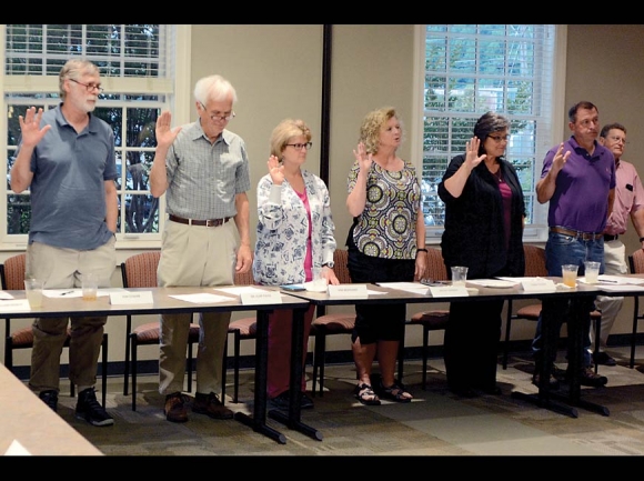 Jerry DeWeese (second from right) takes his oath of office with other board members. Within the hour, he would resign the position. Holly Kays photo
