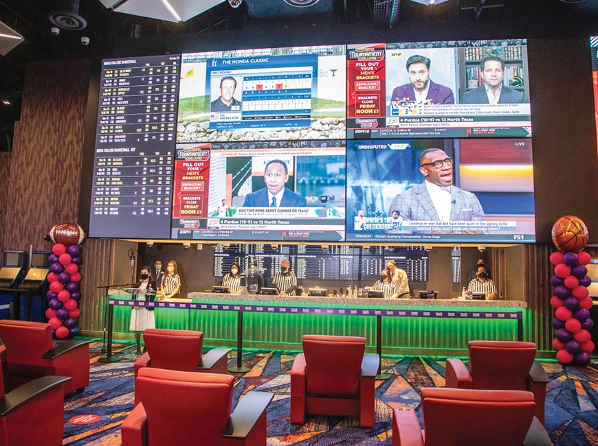 Casino employees stand ready to take the first bets at The Book in Cherokee. Harrah’s Cherokee photo