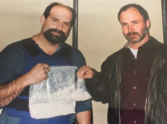 DEA Agent Joel Reece (right) poses in 1998 with what may have been the largest undercover heroin buy in Tennessee history at the time – nearly a pound. Donated photo