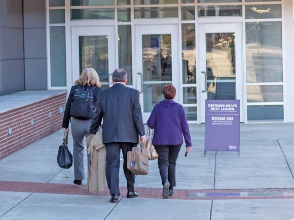 Pat Kaemmerling, chair of the Western Carolina University Board of Trustees and co-chair of the search committee, walks into the Feb. 5 community forum with some of her fellow search committee members. Holly Kays photo