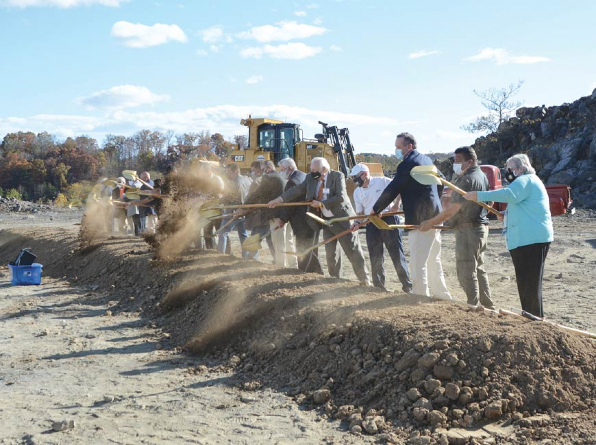 Tribal officials throw ceremonial shovelfuls of earth at a November 2020 groundbreaking ceremony on the Exit 407 property in Sevier County.