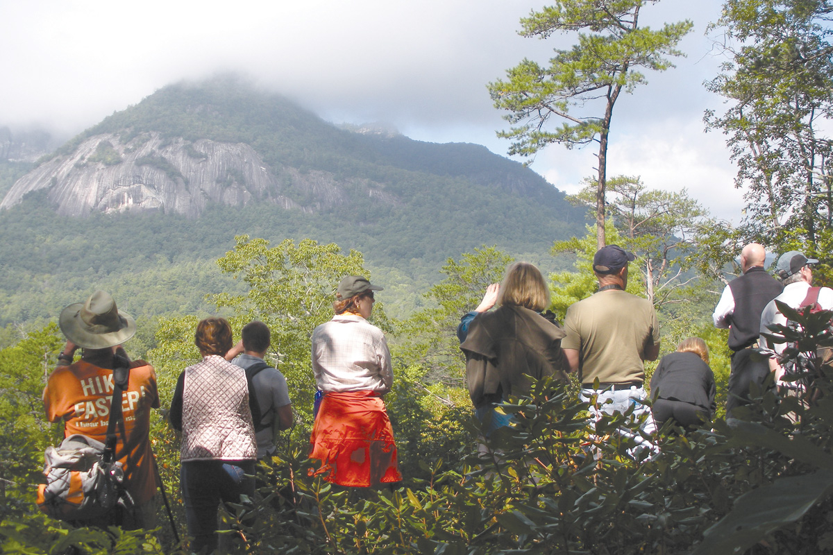 A group takes an HCLT EcoTour in Whiteside Cove with view of Whiteside Mountain. Donated photo
