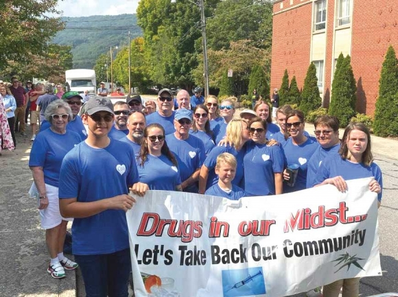 Michele Rogers (center) participates in a community prayer walk organized by Drugs in Our Midst, a local program that educates students and community members about substance use. Donated photo