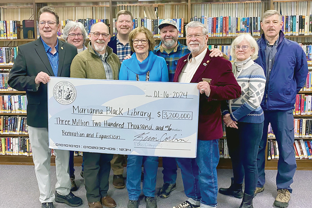 Senator Kevin Corbin (left) and Representative Mike Clampitt (third from right) present members of the Mariana Black Library Board and the Swain County Commission with $3.2 million in state funding for the library expansion project. Hannah McLeod photo